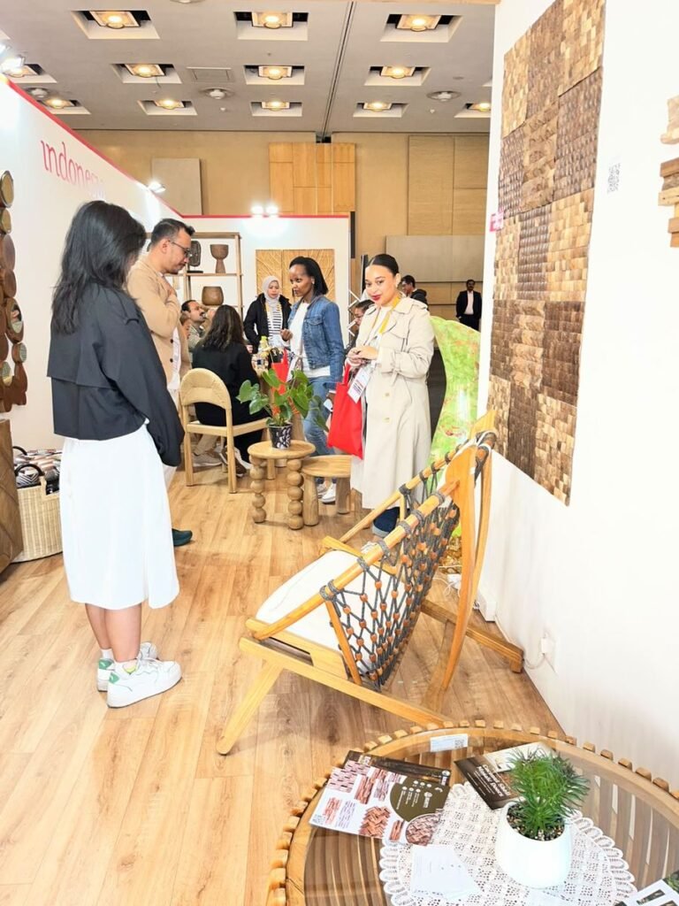 Coconut shell mosaic wall panels on display at the Indonesia Pavilion, with a teak rope chair and product catalogues