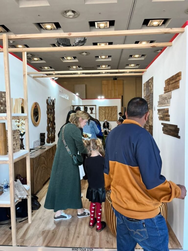 Visitors looking at teak wall cladding samples displayed at the Indonesia Pavilion, Decorex Johannesburg